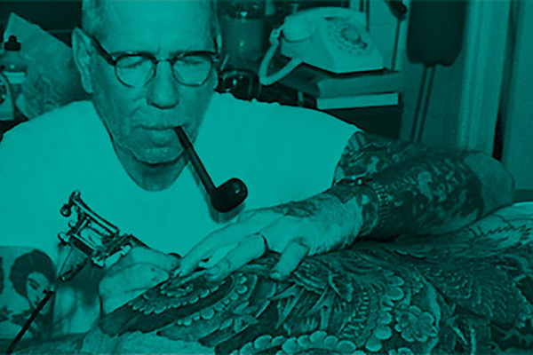 Norman "Sailor Jerry" Collins at work in his tattoo parlour
