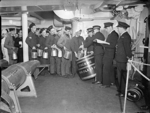 Navy sailors lining up for grog on the HMS King George, 1940