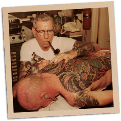 Sailor Jerry tattooing a customer's back